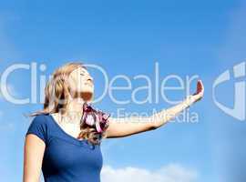 Attractive  blond woman against blue sky