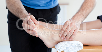 Close-up of a Caucasian physical therapist giving a foot massage