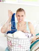 Disgusted woman doing her laundry