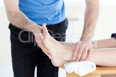 Close-up of a physical therapist giving a foot massage