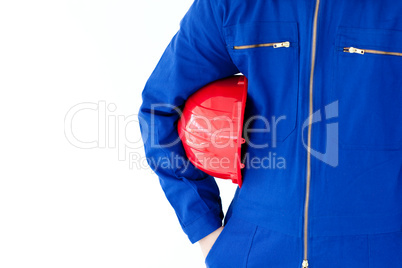 Close-up of a  man holding a red hardhat