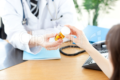 Close-up of a male doctor giving pills to a paient