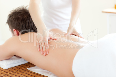 Caucsasian young  man receiving a back massage