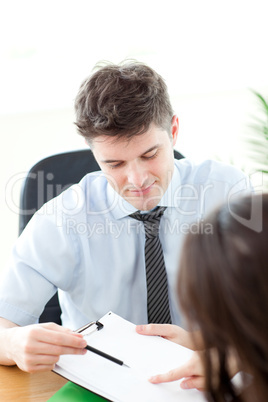 Assertive businessman showing a contract to a customer