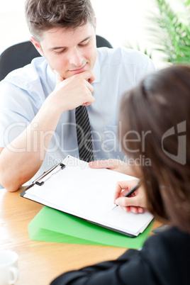 Charismatic  businessman showing a contract to a customer