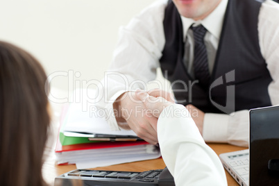 Close-up of two business partners shaking hands