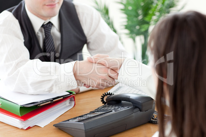 Close-up of two colleagues shaking hands