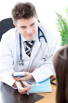 Confident male doctor giving pills to a paient