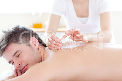Smiling young man in an acupuncture therapy
