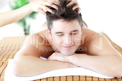 Relaxed man receiving a head massage