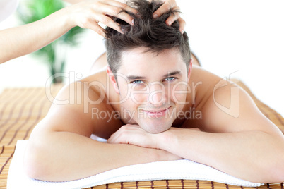 Young man receiving a head massage