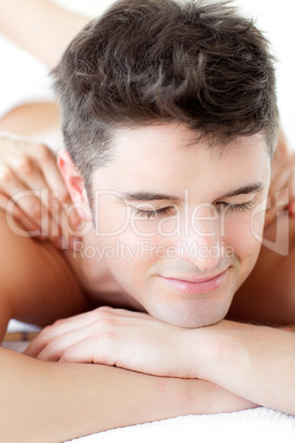 Smiling man enjoying a back massage