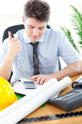 Concentrated male architect studying a project