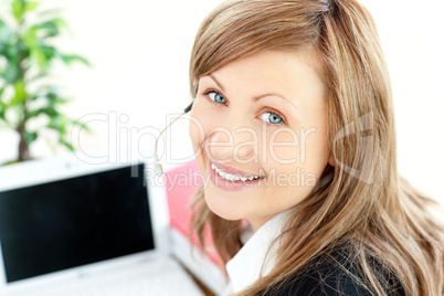 Beautiful businesswoman with headset on smiling at the camera