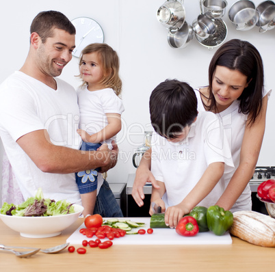 Loving young family cooking together