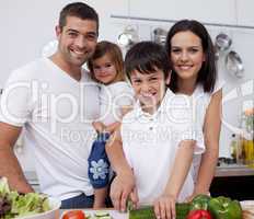 Affectionate young family cooking together