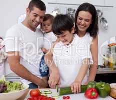 Happy young family cooking together