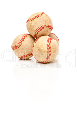Four Baseballs Isolated on Reflective White