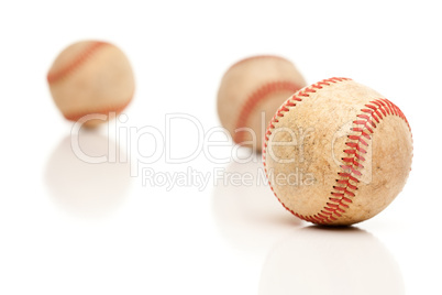 Three Baseballs Isolated on Reflective White