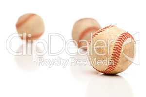 Three Baseballs Isolated on Reflective White