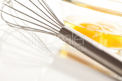 Hand Mixer with Eggs in Glass Bowl