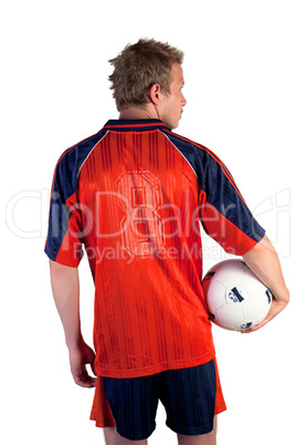 Football player posing with ball in hands on a white background