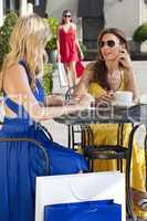 Two Beautiful Young Women Having Coffee With Shopping Bags