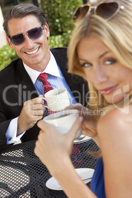 Attractive Businessman and Woman Couple Drinking Coffee At Outdo