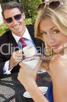 Attractive Businessman and Woman Couple Drinking Coffee At Outdo