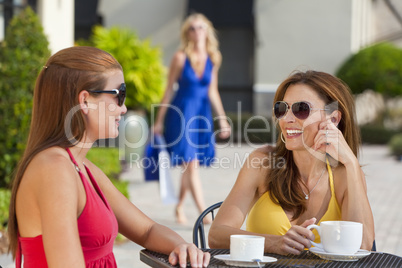 Three Beautiful Young Women Having Coffee With Shopping Bags