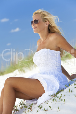 Beautiful Blond Woman in White Dress and Sunglasses At Beach