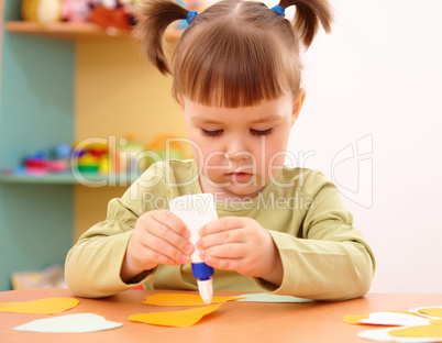 Little girl doing arts and crafts in preschool