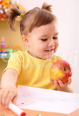 Little girl with apple