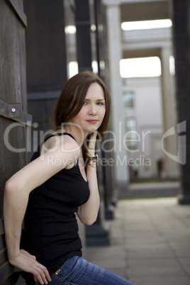 Young woman stand near column