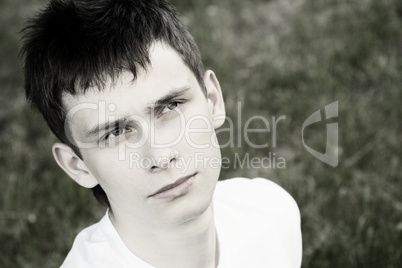 Young man sits in the park