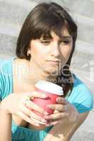 Female in a park drinking coffee