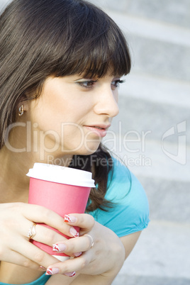 Female in a park drinking coffee