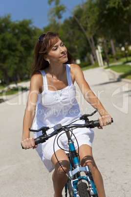 Beautiful Woman Cycling In White Sun Dress