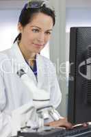 Female Scientist or Doctor Using Computer In Laboratory