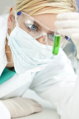 Female Scientist or Doctor With Green Test Tube In Laboratory