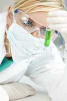 Female Scientist or Doctor With Green Test Tube In Laboratory