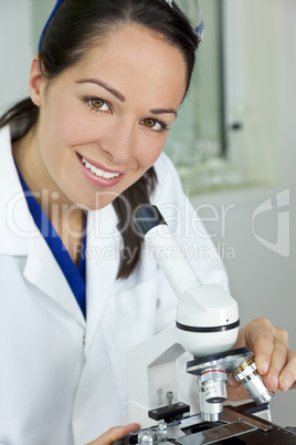 Female Scientist Using Microscope in Laboratory