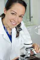 Female Scientist Using Microscope in Laboratory