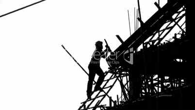 Construction site and workers silhouette