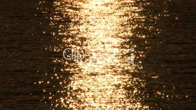 Golden light sparkles on ocean waves