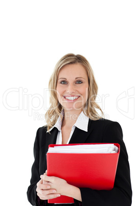 A portrait of a smiling woman holding a file