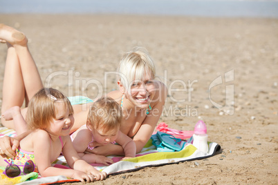 A laughing family lying at the beach