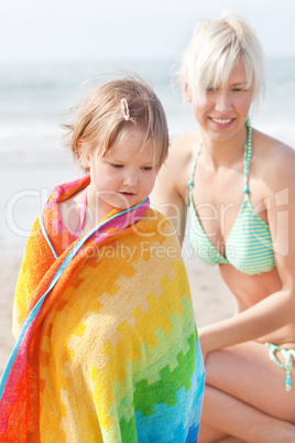 An interested girl and her mother at the beach