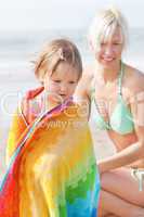 An interested girl and her mother at the beach