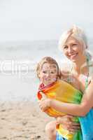 A cheerful girl and her smiling mother at the beach